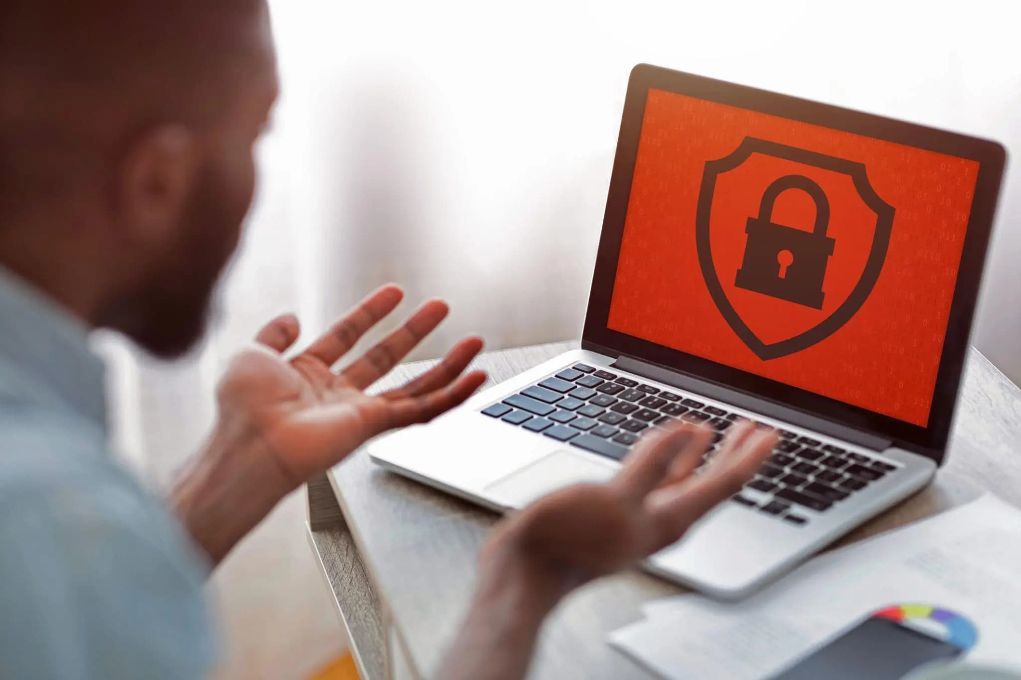 Frustrated man gesturing at a red padlock screen on his laptop, needing to reinstate Florida LLC.